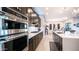 A well-designed kitchen featuring black cabinetry, stainless steel appliances, and a large island with a quartz countertop at 40195 N Hailey Ln, Queen Creek, AZ 85140