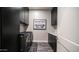 Modern laundry room with black cabinets, countertop, and a stylish laundry-themed sign at 40195 N Hailey Ln, Queen Creek, AZ 85140