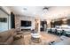 Open-concept living space with a stone accent wall, modern fireplace, and a glimpse of the kitchen at 40195 N Hailey Ln, Queen Creek, AZ 85140