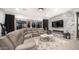 Spacious living room with stone accent wall, fireplace, comfortable seating, and sliding doors for indoor-outdoor living at 40195 N Hailey Ln, Queen Creek, AZ 85140