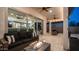 Relaxing covered patio with comfortable seating around a modern fire pit, and a seamless transition to the indoor living space at 40195 N Hailey Ln, Queen Creek, AZ 85140