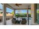 Inviting covered patio featuring comfortable seating with a view of the sparkling swimming pool and landscaped backyard at 40195 N Hailey Ln, Queen Creek, AZ 85140