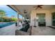 Expansive covered patio with ceiling fans offering a seamless transition to the beautiful pool and meticulously maintained yard at 40195 N Hailey Ln, Queen Creek, AZ 85140