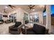 Covered patio with comfortable seating, ceiling fans, and a view of the landscaped backyard; perfect for relaxation at 40195 N Hailey Ln, Queen Creek, AZ 85140