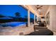 Elegant covered patio with comfortable seating and open views of the pool and backyard at 40195 N Hailey Ln, Queen Creek, AZ 85140