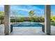 Charming pool area viewed from the covered patio, showcasing a meticulously landscaped backyard with lush greenery and serene ambiance at 40195 N Hailey Ln, Queen Creek, AZ 85140