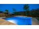 Backyard pool area featuring lounge chairs, shade umbrellas, and lush landscaping, perfect for outdoor enjoyment at 40195 N Hailey Ln, Queen Creek, AZ 85140