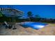 Inviting pool featuring lounge chairs, umbrellas, and well-manicured landscaping, perfect for outdoor living at 40195 N Hailey Ln, Queen Creek, AZ 85140