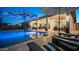 Serene backyard showcasing a sparkling pool, comfortable patio seating, and chic black and white resort umbrellas at 40195 N Hailey Ln, Queen Creek, AZ 85140