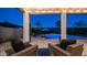 Charming backyard with comfortable seating area overlooking the refreshing pool with resort umbrellas at 40195 N Hailey Ln, Queen Creek, AZ 85140