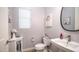 Charming powder room featuring a pedestal sink, elegant fixtures, and decorative accents at 40195 N Hailey Ln, Queen Creek, AZ 85140