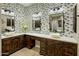 Bathroom featuring dual sinks, custom wood cabinetry, stone flooring and mosaic tile wall design at 4426 E Capricorn Pl, Chandler, AZ 85249