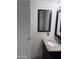 Features a granite vanity top and tile shower, and includes a white door and decorative mirror at 4436 E Pueblo E Ave, Phoenix, AZ 85040