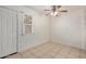 A well-lit bedroom featuring neutral walls, a ceiling fan, and access to outdoor space at 4436 E Pueblo E Ave, Phoenix, AZ 85040