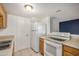 Efficient kitchen with white appliances, neutral countertops, and views into other living areas at 4436 E Pueblo E Ave, Phoenix, AZ 85040