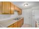 Functional kitchen featuring neutral counters, white appliances, and ample cabinet storage space at 4436 E Pueblo E Ave, Phoenix, AZ 85040