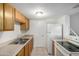Functional kitchen featuring neutral counters, white appliances, and ample cabinet storage space at 4436 E Pueblo E Ave, Phoenix, AZ 85040