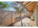 Enclosed backyard patio with brick flooring, stucco walls, and lush landscaping at 4530 W Continental Dr, Glendale, AZ 85308