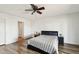 Bright bedroom features a ceiling fan, wood floors, and a sliding door to the backyard at 4530 W Continental Dr, Glendale, AZ 85308