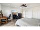 Bright bedroom features a ceiling fan, wood floors, dresser, and two closets for storage at 4530 W Continental Dr, Glendale, AZ 85308