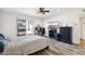 Bright bedroom features a ceiling fan, wood floors, a sliding door to the backyard, and desk at 4530 W Continental Dr, Glendale, AZ 85308