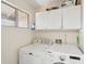 Laundry room featuring modern washer and dryer with lots of storage at 4530 W Continental Dr, Glendale, AZ 85308