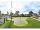 Artificial putting green with string lights and mature trees at 4530 W Continental Dr, Glendale, AZ 85308