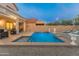 Backyard featuring a swimming pool with an integrated spa, chaise lounges, and desert rock landscaping at 4535 W Cottontail Rd, Phoenix, AZ 85086