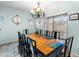 Formal dining room featuring a large table with seating for eight and a decorative chandelier at 4535 W Cottontail Rd, Phoenix, AZ 85086