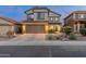 Two-story home featuring a tidy desert rock garden, a two-car garage, and well-kept landscaping at 4535 W Cottontail Rd, Phoenix, AZ 85086