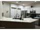 Modern kitchen boasts white cabinets, stainless steel appliances, and elegant countertops at 4535 W Cottontail Rd, Phoenix, AZ 85086