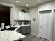 Well-designed kitchen featuring gray lower cabinets and white upper cabinets at 4535 W Cottontail Rd, Phoenix, AZ 85086