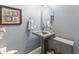 Close up shot of a powder room with a decorative sink and textured gray wallpaper at 4535 W Cottontail Rd, Phoenix, AZ 85086