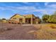 View of the backyard showing the back of the home and a large covered patio at 4937 S Peach Willow Ln, Gilbert, AZ 85298
