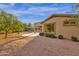 Backyard features mature fruit trees and view of the covered patio and landscaped yard at 4937 S Peach Willow Ln, Gilbert, AZ 85298