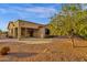 Backyard showing mature citrus tree and home's covered patio area at 4937 S Peach Willow Ln, Gilbert, AZ 85298