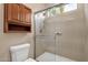 Bathroom featuring a shower with glass doors, storage, and a toilet at 4937 S Peach Willow Ln, Gilbert, AZ 85298