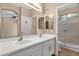 Bathroom featuring double vanity, framed mirror, and shower at 4937 S Peach Willow Ln, Gilbert, AZ 85298