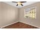 Bedroom featuring hard wood floors and a window with blinds at 4937 S Peach Willow Ln, Gilbert, AZ 85298