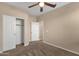 Neutral bedroom with a ceiling fan and closet at 4937 S Peach Willow Ln, Gilbert, AZ 85298
