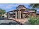Inviting clubhouse entrance with stone pillars, covered walkway, and well-maintained landscaping at 4937 S Peach Willow Ln, Gilbert, AZ 85298