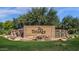 Beautiful Trilogy community entrance sign with waterfall feature and meticulously maintained landscaping at 4937 S Peach Willow Ln, Gilbert, AZ 85298