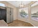 Cozy dining area with two windows for ample light, a modern light fixture and gray cabinets at 4937 S Peach Willow Ln, Gilbert, AZ 85298