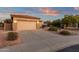 Single-Gathering home with a long driveway, desert landscaping, and a two-car garage at 4937 S Peach Willow Ln, Gilbert, AZ 85298