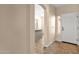 Bright entryway with tiled floors, a white front door, and an arched opening to the living area at 4937 S Peach Willow Ln, Gilbert, AZ 85298