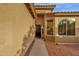 Inviting home entrance featuring a secure black metal door and decorative desert landscaping at 4937 S Peach Willow Ln, Gilbert, AZ 85298