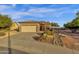Inviting single-Gathering home showcasing a well-manicured front yard and a two-car garage at 4937 S Peach Willow Ln, Gilbert, AZ 85298