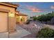 Single-Gathering home with desert landscaping, rock features, and a beautiful blue and orange sunset at 4937 S Peach Willow Ln, Gilbert, AZ 85298