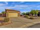 Home's appealing exterior features a two-car garage and low-maintenance landscaping at 4937 S Peach Willow Ln, Gilbert, AZ 85298