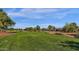 Lush green golf course next to beautiful homes in the community at 4937 S Peach Willow Ln, Gilbert, AZ 85298